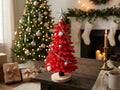 A red textured  Chenille Christmas tree with a silver star topper, silver garland, and white ornaments stands on a round wooden base.